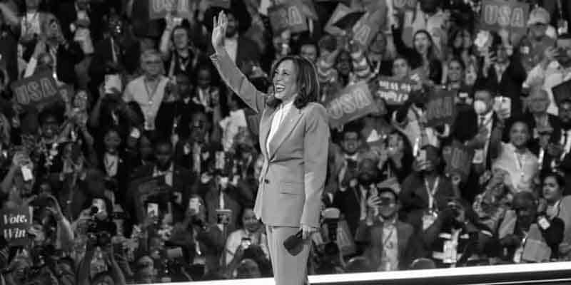 Kamala Harris waving to a crowd of supporters